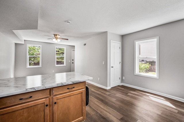 1415 Galtier St, Saint Paul, MN 55117 - kitchen with dark wood finished floors, a ceiling fan, baseboards, brown cabinetry, and a textured ceiling