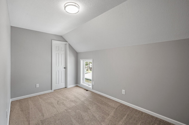 1415 Galtier St, Saint Paul, MN 55117 - bonus room featuring vaulted ceiling, carpet flooring, baseboards, and a textured ceiling
