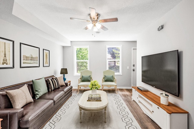 1415 Galtier St, Saint Paul, MN 55117 - living area with a textured ceiling, a ceiling fan, wood finished floors, and baseboards