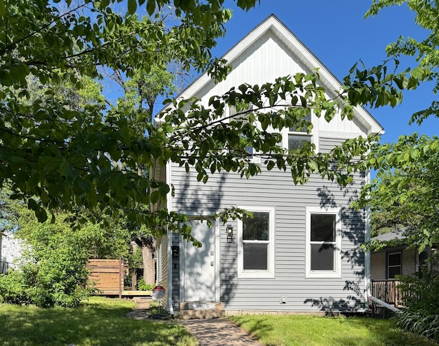 1415 Galtier St, Saint Paul, MN 55117 - back of house featuring a yard and board and batten siding
