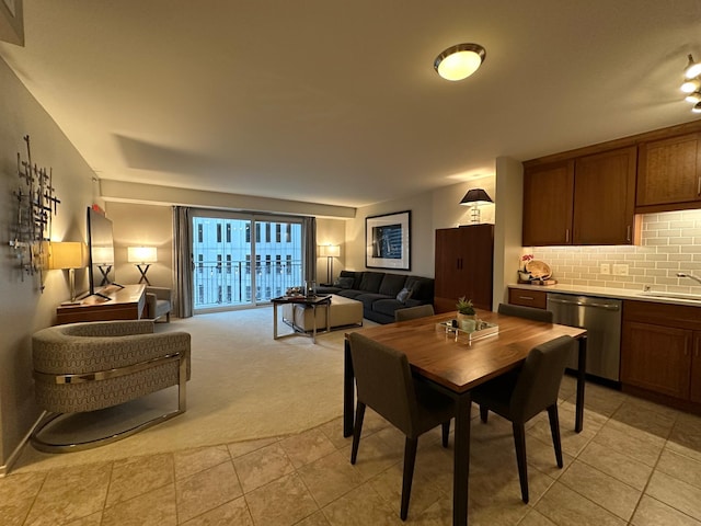 carpeted dining room with sink