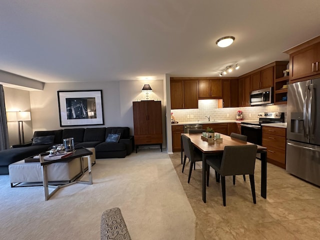 carpeted dining area featuring sink