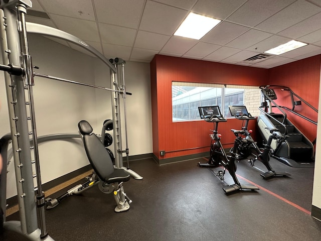 workout room with a drop ceiling