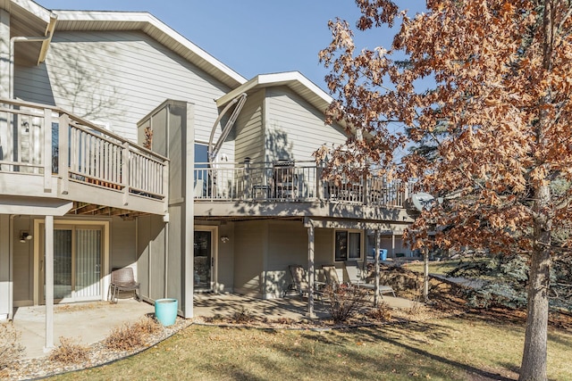 rear view of house featuring a yard and a patio area