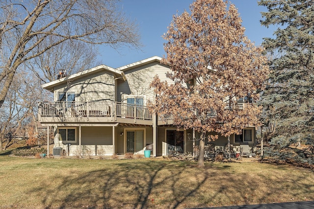 rear view of house featuring central AC, a lawn, and a deck