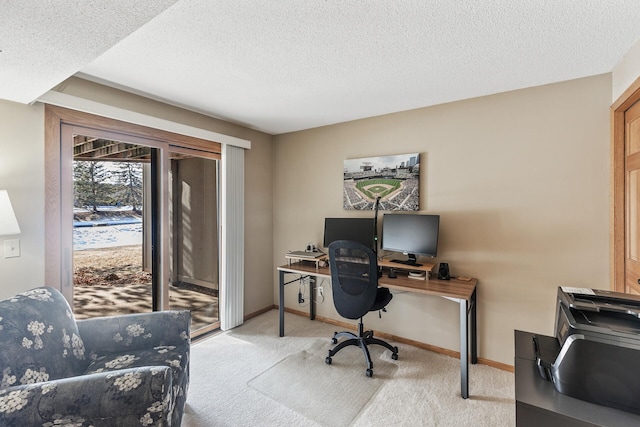 office area with light colored carpet and a textured ceiling