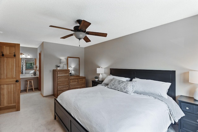 bedroom featuring ceiling fan, light carpet, and a textured ceiling