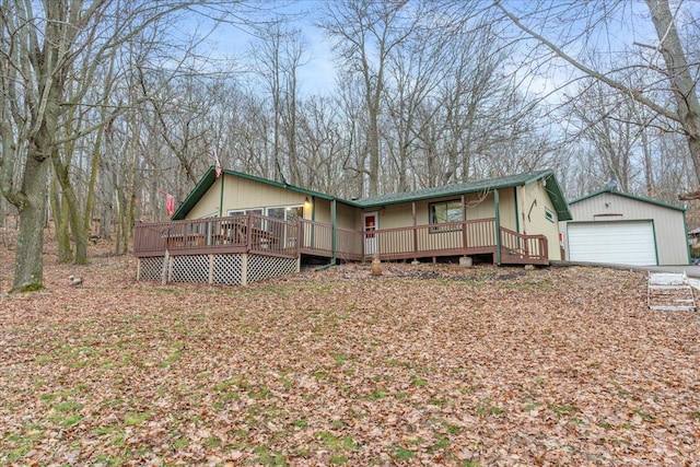 view of front of house featuring a deck, a garage, and an outdoor structure