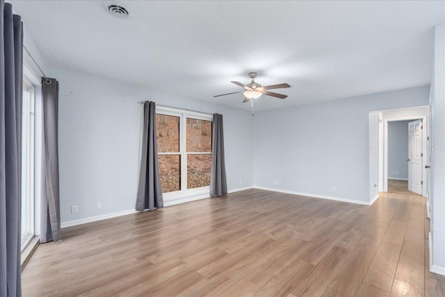 unfurnished room with ceiling fan, light hardwood / wood-style flooring, and plenty of natural light