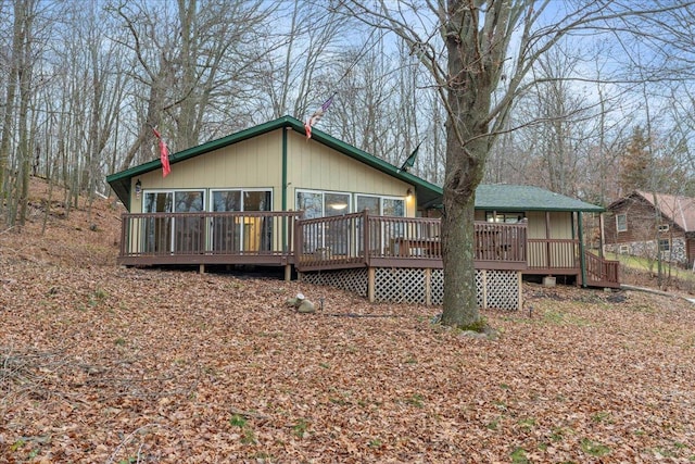 back of house featuring a wooden deck