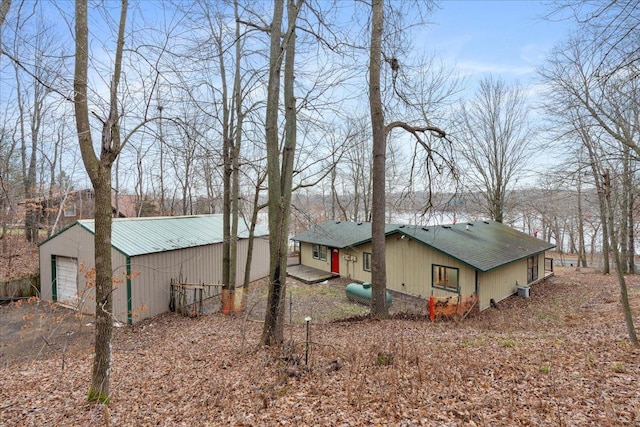 view of home's exterior with an outbuilding, a garage, and central AC unit