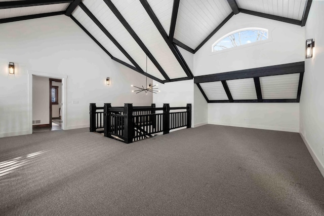 interior space with ceiling fan, carpet flooring, beam ceiling, and high vaulted ceiling