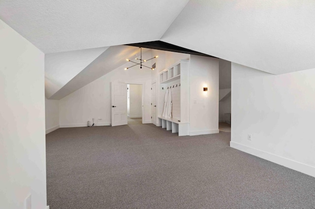 bonus room with a textured ceiling, carpet, lofted ceiling, and a notable chandelier