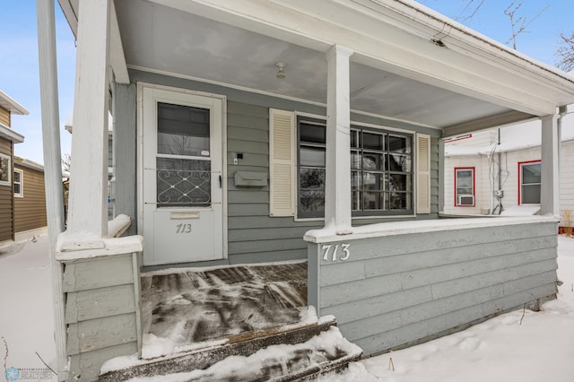 doorway to property featuring covered porch