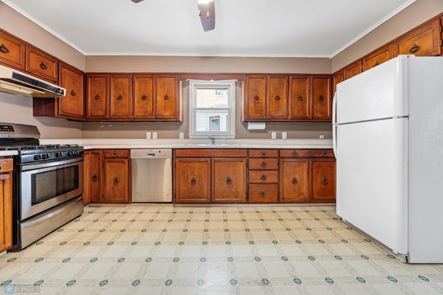 kitchen with ceiling fan, sink, ornamental molding, and appliances with stainless steel finishes