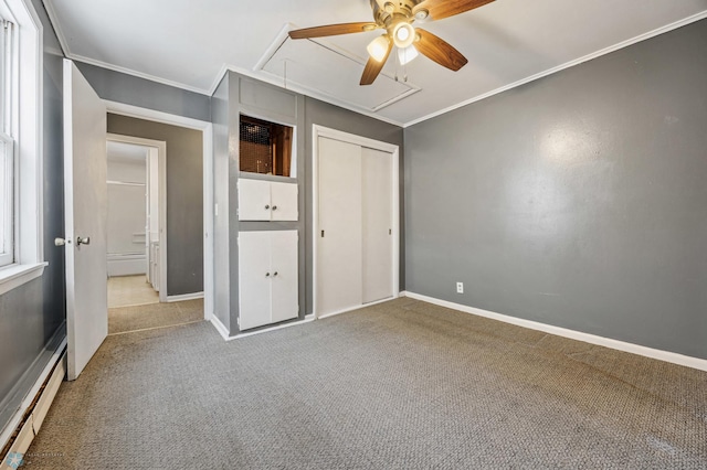 unfurnished bedroom featuring ceiling fan, a baseboard radiator, crown molding, carpet floors, and a closet