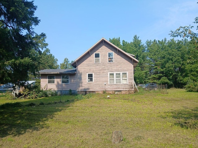 view of side of home featuring a yard