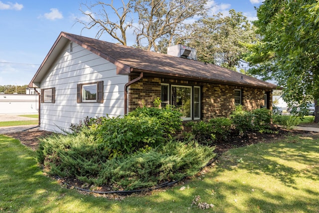 view of side of property with a yard