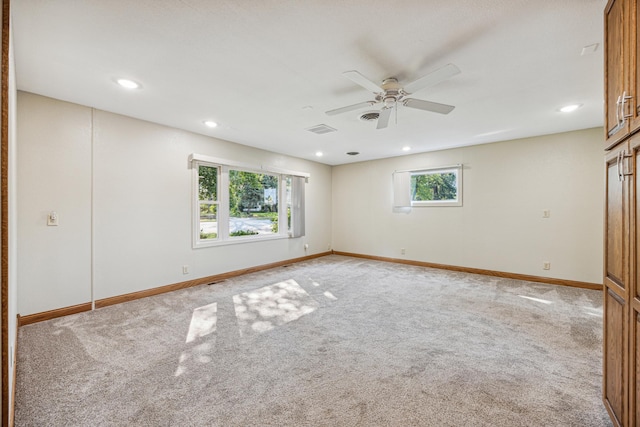 carpeted empty room featuring ceiling fan