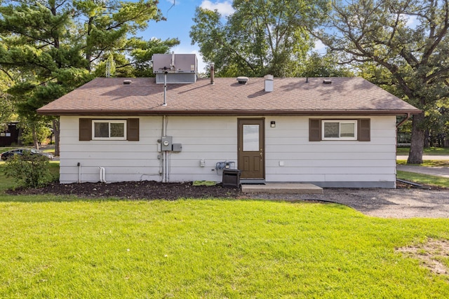 back of house with a lawn