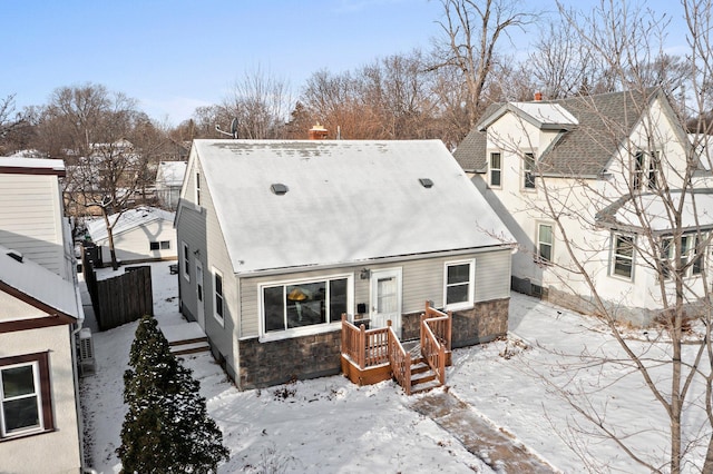 view of snow covered rear of property