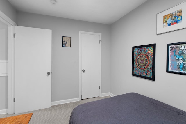 bedroom featuring light carpet