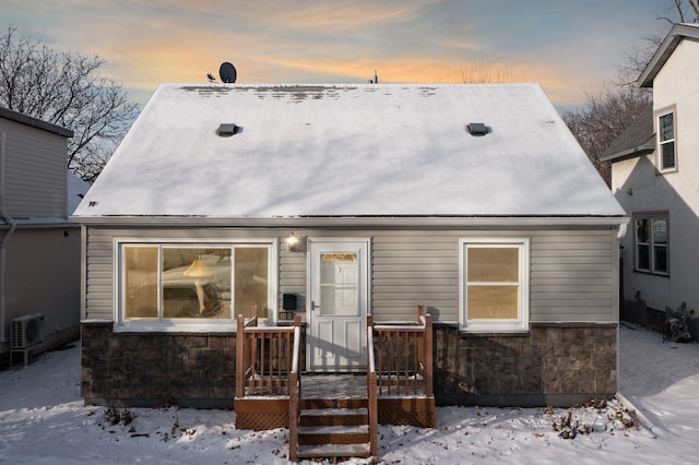 view of snow covered back of property