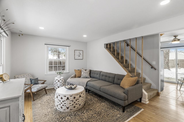 living room with ceiling fan, plenty of natural light, and light hardwood / wood-style floors