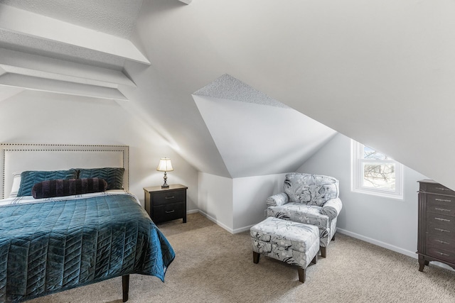 bedroom with baseboards, vaulted ceiling, and light colored carpet