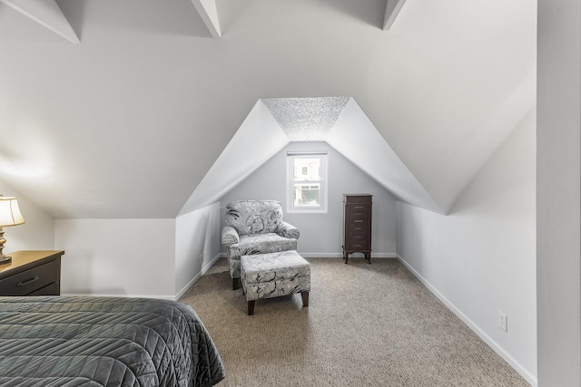 carpeted bedroom with lofted ceiling and baseboards