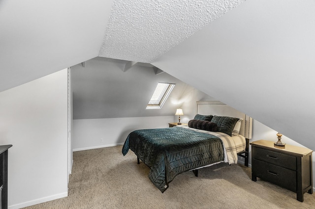 bedroom with baseboards, lofted ceiling with skylight, and light colored carpet