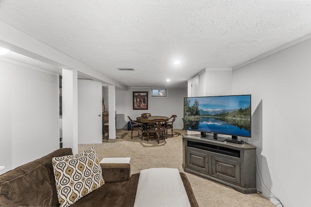 living room featuring a textured ceiling, visible vents, and light colored carpet