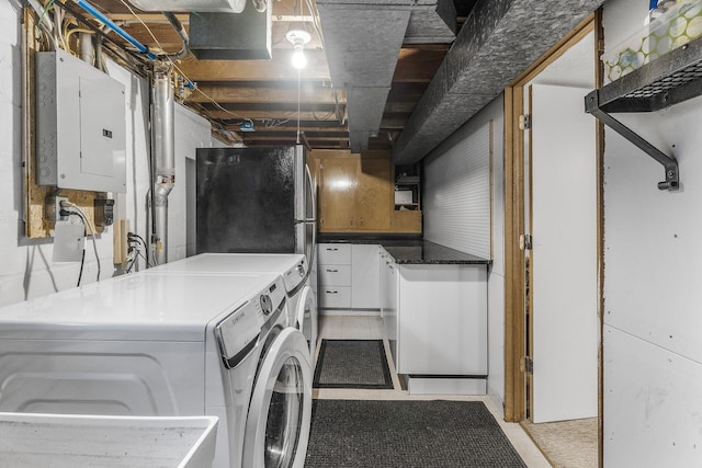 clothes washing area featuring laundry area, separate washer and dryer, and electric panel