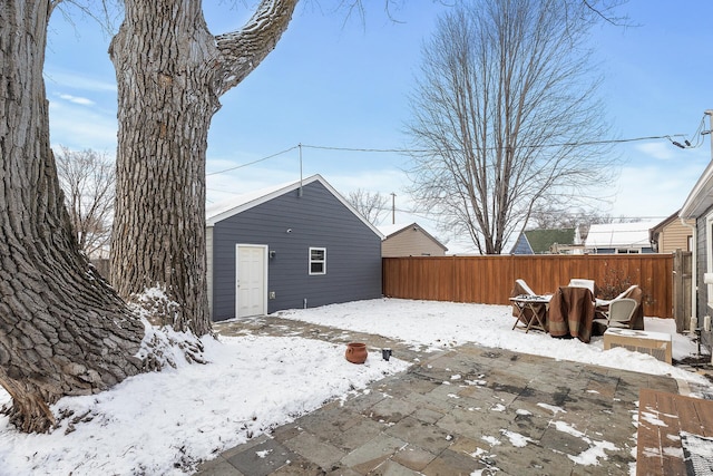 snowy yard with fence and an outdoor structure