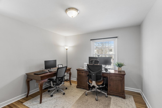 office with light wood-style floors and baseboards