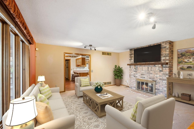 living room featuring a textured ceiling and a fireplace