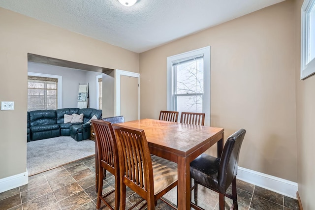 dining space featuring a textured ceiling