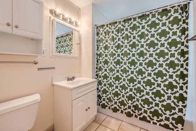 bathroom featuring toilet, vanity, tile patterned floors, and walk in shower