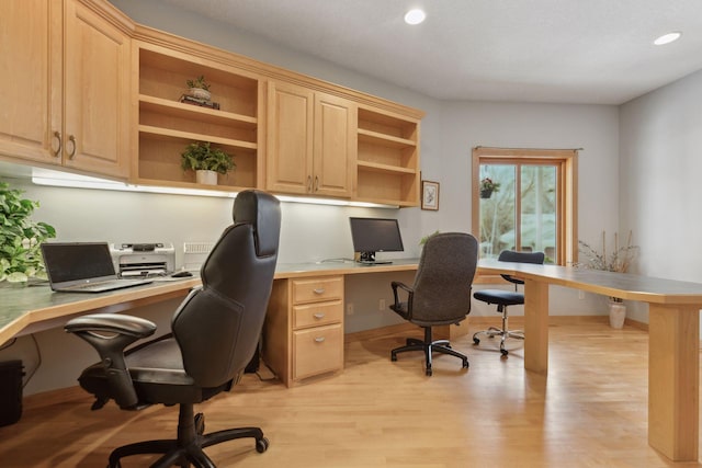 office area with built in desk and light hardwood / wood-style floors