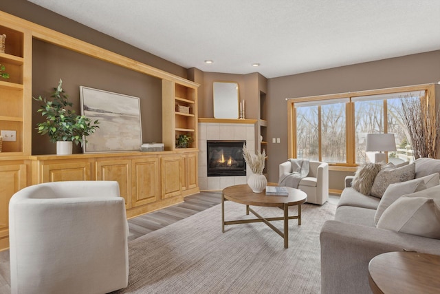 living room with a tiled fireplace