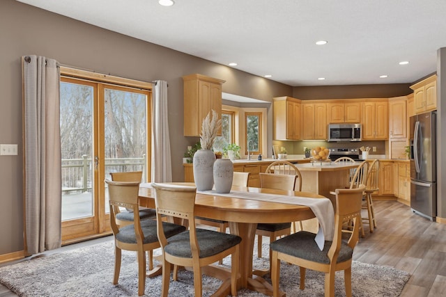 dining space with light hardwood / wood-style flooring