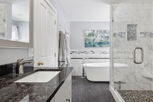 bathroom with vanity, shower with separate bathtub, and tile walls