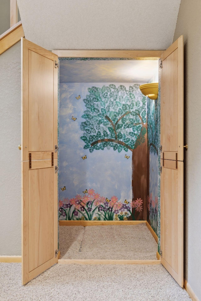 doorway featuring a textured ceiling and carpet