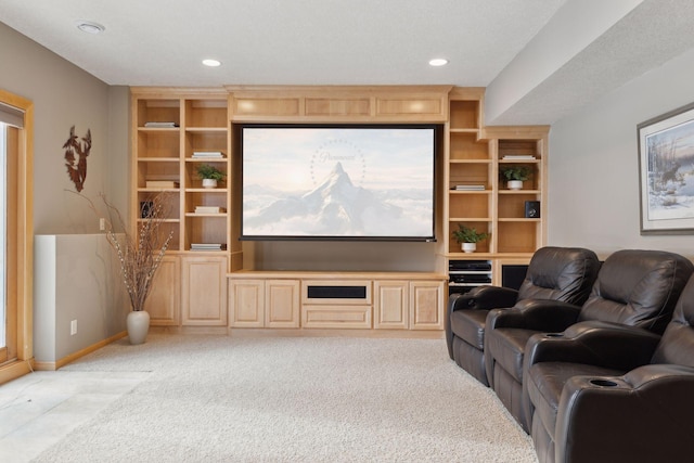 home theater room with light carpet and built in features