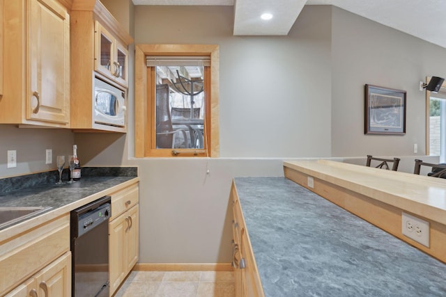 kitchen featuring white microwave, light tile patterned flooring, dishwasher, and light brown cabinets