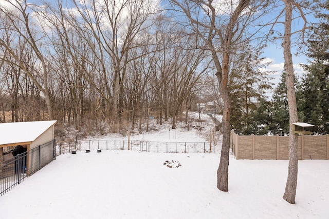 snowy yard featuring an outdoor structure