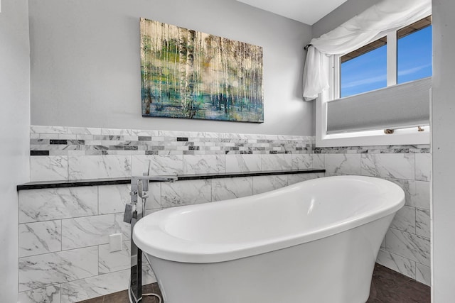 5061 Oxbow Pl, Champlin, MN 55316 - full bathroom with a freestanding tub, marble look tiles, and tile walls
