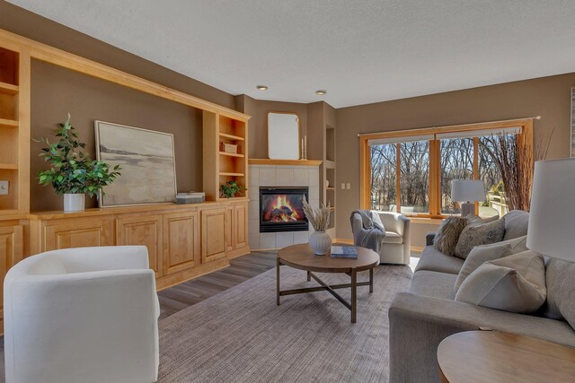 5061 Oxbow Pl, Champlin, MN 55316 - living room featuring a tile fireplace, wood finished floors, and built in features