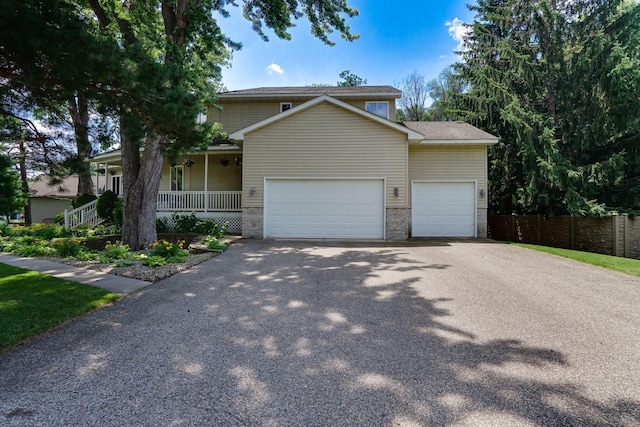 5061 Oxbow Pl, Champlin, MN 55316 - traditional-style house with asphalt driveway, a garage, and a porch