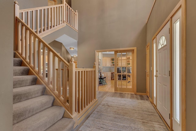 5061 Oxbow Pl, Champlin, MN 55316 - entrance foyer featuring a towering ceiling, wood finished floors, and stairs